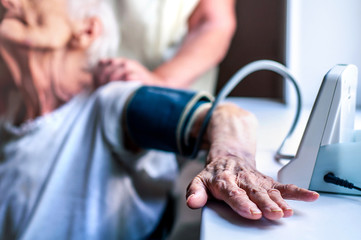 Hand of an elderly woman for 90 years. Blood pressure measurement. Hypertension at risk for coronavirus. Old people die from COVID-19. Grandma's wrinkled hand. Art noisemeasuremen