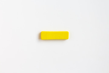 yellow painted wooden minus, craft sign for kid's education isolated, ecological concept