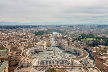 Fototapeta premium Aerial view of St Peter's square in Vatican City, Rome, Italy. Sunny spring day with clouds.