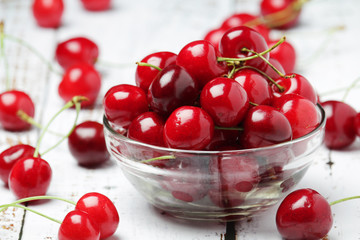 A small glass bowl with ripe fresh cherry	