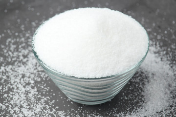 A glass bowl with white sugar