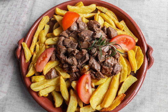 Traditional dish of Madeira island, called &ldquo;Picado&rdquo; or &ldquo;Picadinho&rdquo;, prepared with beef cut into small cubes, fried chips sliced tomatoes and garlic.
