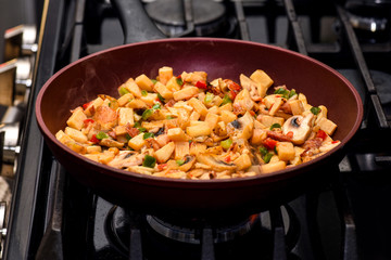 Breakfast hash in frying pan on stove