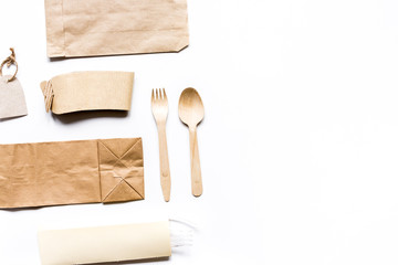 food delivery with paper bags and flatware on gray table background top view mockup