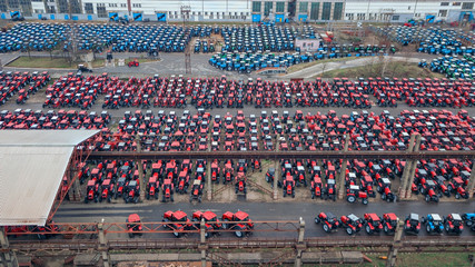 Aerial view of warehouse of tractors. Business and industrial concept.