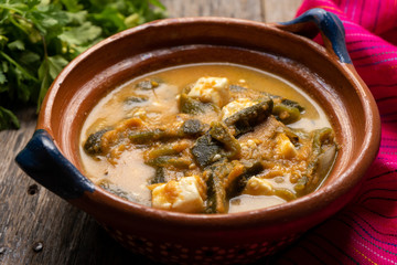 Mexican poblano pepper rajas and panela cheese on wooden background