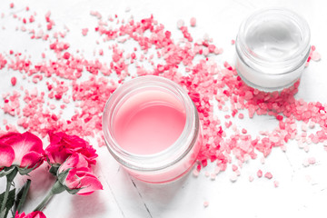 Fototapeta na wymiar rose salt and cream for nail care in spa on white background
