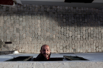 man leaning out the window