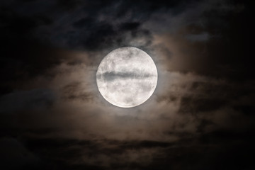 Fototapeta na wymiar Full moon amongst the clouds