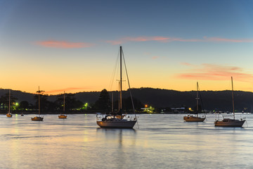Fototapeta na wymiar Sunrise over the Bay with Boats