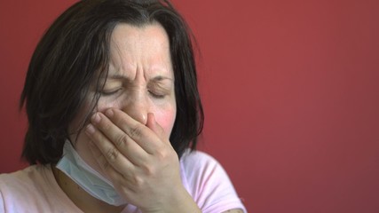 Fototapeta premium The young woman is ill. Coughing. Antibacterial protection. Dark hair. Viral infection. Close-up.