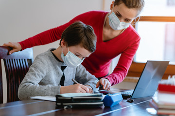 School student learning in video chat with teacher in e-learning