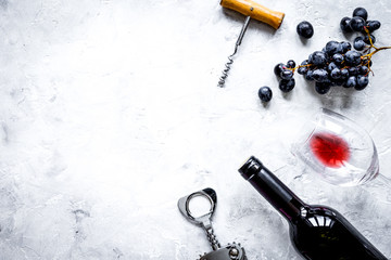 bottle of red wine and corkscrew on stone background top view mockup