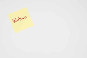 Wuhan in bold red lettering on a yellow sticky note with copyspace
