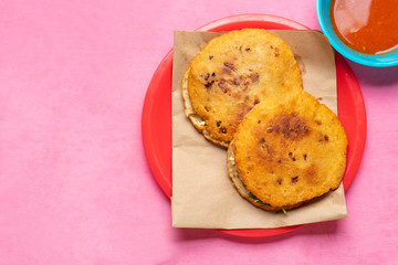 Mexican fried gorditas on pink background