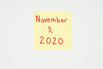 November 3, 2020 written on a yellow sticky note with copyspace. Presidential election 2020