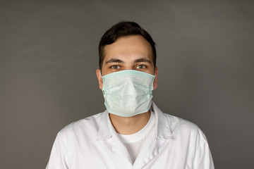 Portrait of a doctor in a medical gown and protective mask.