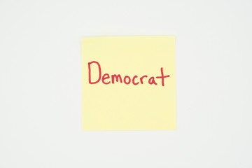 Democrat written on a yellow sticky note with copyspace. Presidential election 2020