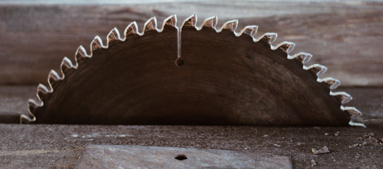 Close-up metal dish electric saw in iron table.