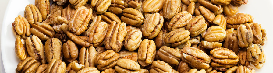 Pecan nuts background. Closeup pekan seeds