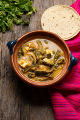 Mexican poblano pepper rajas and panela cheese on wooden background