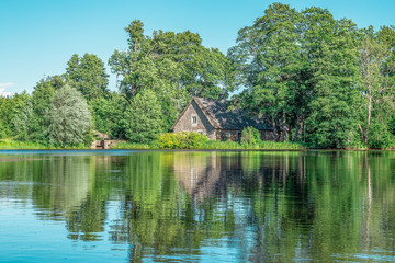 Obraz premium old water mill over the lake