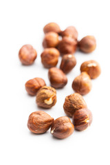 Peeled hazelnuts on white background.