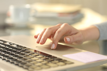 Woman hand with laptop using touchpad on a desk - obrazy, fototapety, plakaty