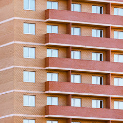 Naklejka premium Balconies and windows of the new brick apartment house.