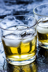 glass of whiskey on dark background