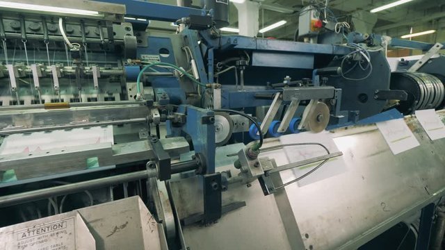 Paper pages are moving through a binding conveyor