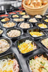 Food delivery. Different in plastic disposable lunch box with healthy natural food. Chicken broth, mashed soup, mashed potatoes with cutlet, seafood pasta, salads, pilaf with a fresh bun.