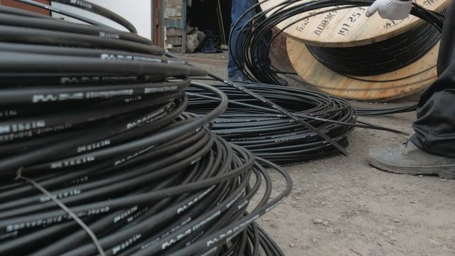 Close-up. fiber optic cable on a large wooden spool.