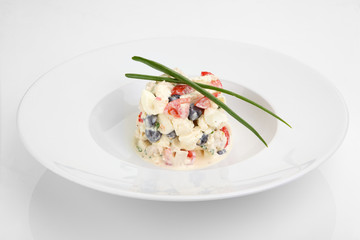 Salad with fresh vegetables, eggs and chicken meat on white plate