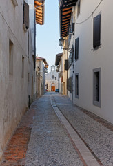 Fototapeta premium Street Leading to Santa Maria Church in San Daniele del Friuli, Italy