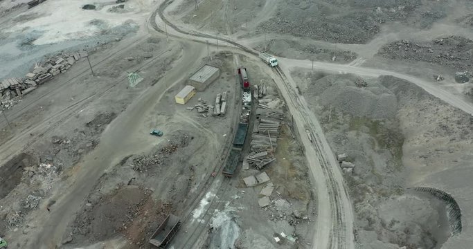 Heavy equipment digs and hauls ore inside an enormus open pit mine.