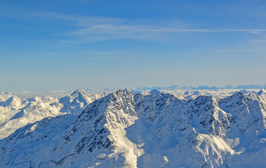 Fototapeta na wymiar Panoramically view over Austrian Alps covered with snow on altitude higher than 3000 meters above the sea during sunny winter day.