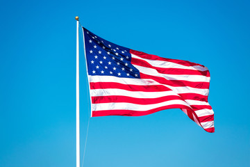 USA Flag. Flag of the United States flying waving beautifully in the wind under blue sky