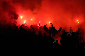  football fans use pyrotechnics after their club win championship.  great bonfire of the yearly celebration 