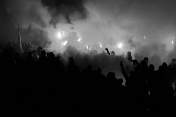 Naklejka na ściany i meble football fans use pyrotechnics after their club win championship. great bonfire of the yearly celebration 
