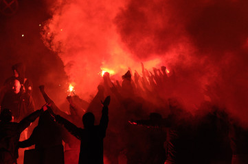  football fans use pyrotechnics after their club win championship.  great bonfire of the yearly celebration 