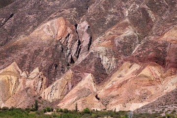 Fototapeta na wymiar Colorful mountains called Painter's Palette in Maimará in the Quebrada de Humahuaca, a narrow mountain valley. Andes mountains, Argentina.
