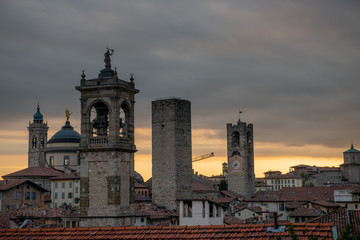 Obraz premium Bergamo at sunset in the old city with towers and bell tower,