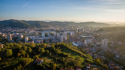 Aerial view of downtown Tuzla at sunset, Bosnia. City photographed by drone, traffic and objects , landscape.Tuzla city photographed by drone from air. Buildings near park. Old balkan city with large 
