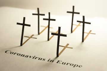 Black grave crosses. Text  "Coronavirus in Europe". The concept of high mortality from coronavirus.