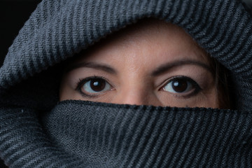 Lady face shot studio extreme closeup portrait. She is wearing a burka.