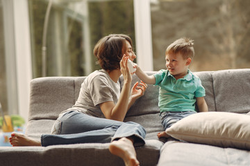 Family stay at home. Mother with little son. Coronavirus theme. Mom gives baby pills.