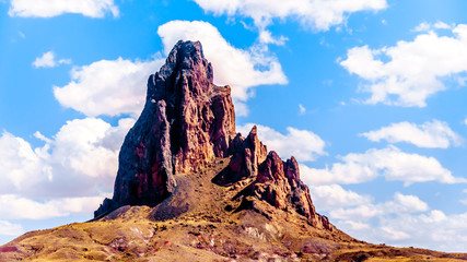 Naklejka premium The rugged peaks of El Capitan and Agathla Peak towering over the desert landscape south of Monument Valley along Highway US Route 163 in northern Arizona, United States