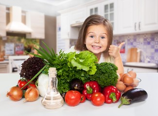 Portrait of adorable little girl preparing healthy food at kitchen