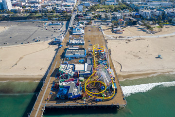 Aerial view of empty Santa Monica pier with no people in Los Angeles California as result of  coronavirus pandemic or COVID-19 virus outbreak, lockdown and quarantine